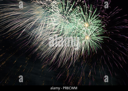 bizarre fireworks background, multicolour festive fireworks in night sky Stock Photo