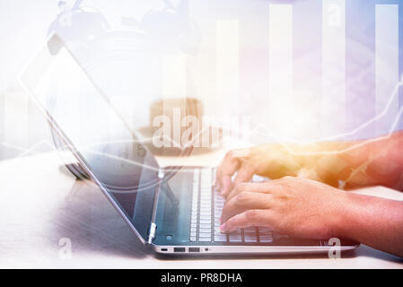 young business man typing laptop, office man working, double exposure illustration graph Stock Photo