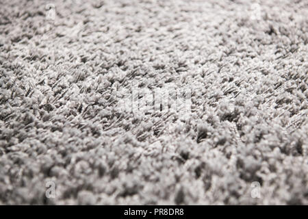 White carpet background texture, close up, gray textile texture, fluffy rug background, Wool fabric texture, beige hairy carpet, fragment shaggy mat, interior, material with pattern abstract. Stock Photo