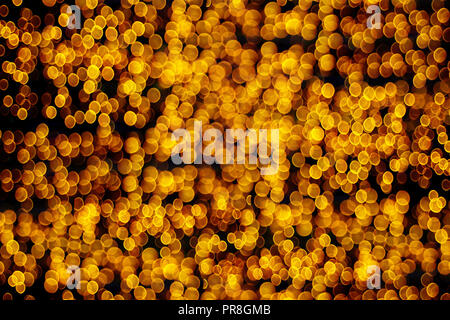 Abstract Christmas lights background, golden glitter defocused texture Stock Photo