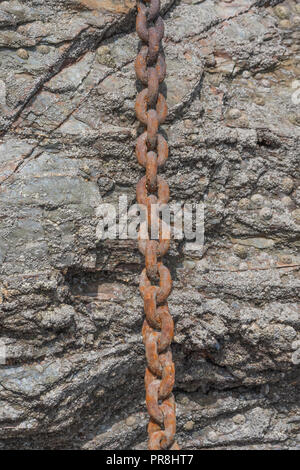 Harbour scenes around Newquay, Cornwall. Rusting mooring chain links. Metaphor strong links, strongest link, forge links, close ties, supply chain. Stock Photo