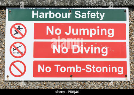 Harbour scenes around Newquay, Cornwall. Harbour safety warning sign - no diving or tomb-stoning. Stock Photo