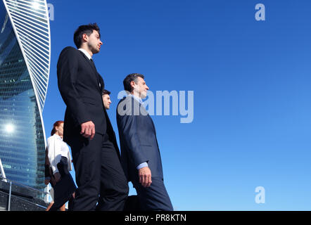 Team of diverse business people outdoors of company office building Stock Photo