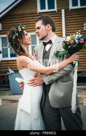 bride and groom in the background of the house. Stock Photo