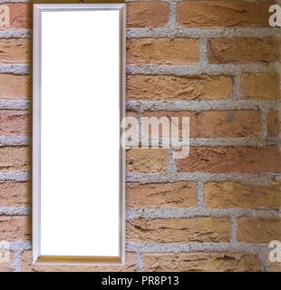 Blank small long white rectangular shaped picture frame hanging on a brick wall background Stock Photo