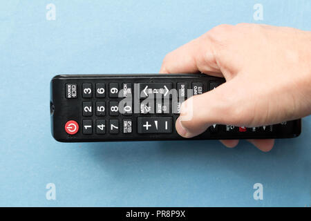 hand holding remote control Stock Photo