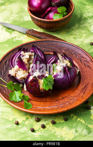 Onions stuffed with bacon and spices.Turkish and Georgian cuisine. Stock Photo