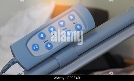 Closeup remote control panel of electric adjustable bed  use for adjust patient's bed for comfortable. Adjustable hospital bed. Remote with 8 blue but Stock Photo