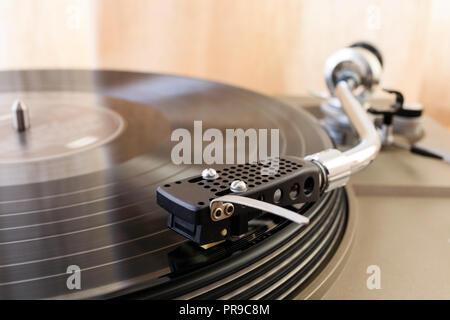 Record player, deck. 'S' shape tone arm playing long player record, LP, vinyl, also known as long playing record. Stock Photo