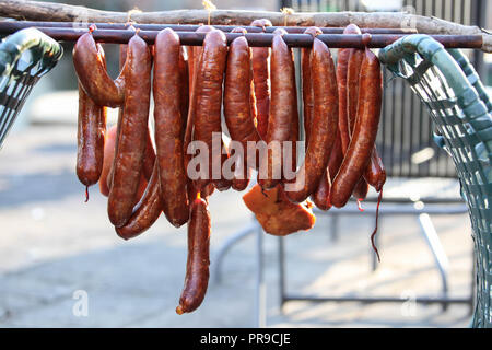 Smoked sausages hanging outside Stock Photo