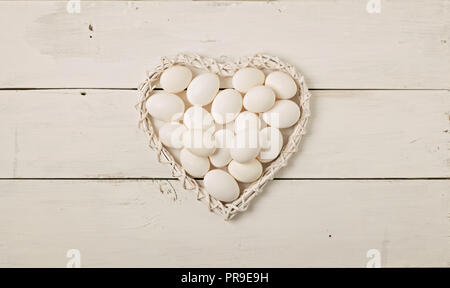 Happy easter. Easter decoration - Easter eggs and flowering branches on a white wooden background. Selective focus. Stock Photo