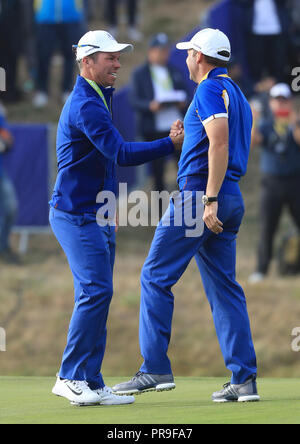 Team Europe's Paul Casey (left) celebrates during the Singles match on day three of the Ryder Cup at Le Golf National, Saint-Quentin-en-Yvelines, Paris. Stock Photo