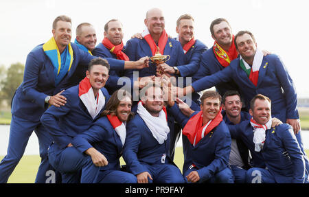 Team Europe's (top row, from the left to right) Henrik Stenson, Alex Noren, Sergio Garcia, captain Thomas Bjorn, Ian Poulter, Jon Rahm, Francesco Molinari (bottom row, from left to right) Justin Rose, Tommy Fleetwood, Tyrrell Hatton, Thorbjorn Olesen, Rory McIlroy and Paul Casey celebrate with the Ryder Cup on day three of the Ryder Cup at Le Golf National, Saint-Quentin-en-Yvelines, Paris. Stock Photo