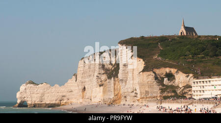 The white chalk cliffs of Etretat, France with sweeping pebble beach and natural arches, a beautiful seaside town in upper Normandy for a day trip Stock Photo