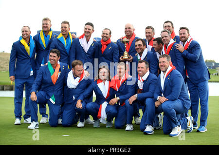 Team Europe's (back left to right), Alex Noren, Robert Karlsson, Henrik Stenson, Justin Rose, Sergio Garcia, Thomas Bjorn, Francesco Molinari, Ian Poulter, Rory McIlroy, Luke Donald, Jon Rahm and Graeme McDowell, (front left to right) Padraig Harrington, Tyrell Hatton, Tommy Fleetwood, Thorbjorn Olesen, Paul Casey and Lee Westwood celebrate with the trophy on day three of the Ryder Cup at Le Golf National, Saint-Quentin-en-Yvelines, Paris. Stock Photo