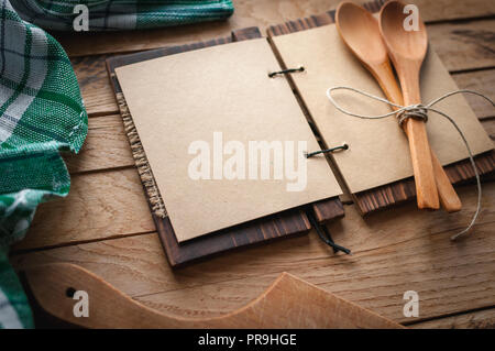 Blank vintage recipe cookbook and utensils on wooden background, copy space Stock Photo