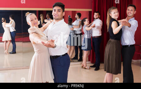 People dancing together slow ballroom dances in pairs Stock Photo
