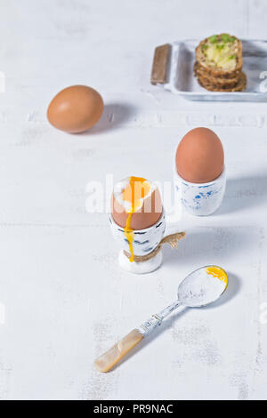 Soft boiled eggs breakfast on white rustic table top background Stock Photo