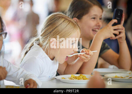 School Holiday summer camp children eating dinner Stock Photo