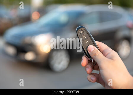 Man opening car with the control remote key. Keyless car system remote control Stock Photo