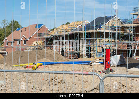 New housing development, Acacia Gardens, by Bewley Homes near Wrecclesham in Surrey, UK. Construction site, building houses properties scaffolding Stock Photo