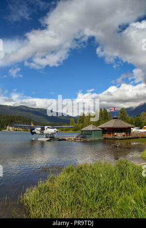 WHISTLER, BC, CANADA - JUNE 2018: Wide angle view of a Whistler Air Turbine Otter aircraft tied up at the jetty of the seaplane terminal in Whistler. Stock Photo