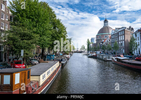 This is a picture of boats lined up along on of Amsterdams Canals Stock Photo