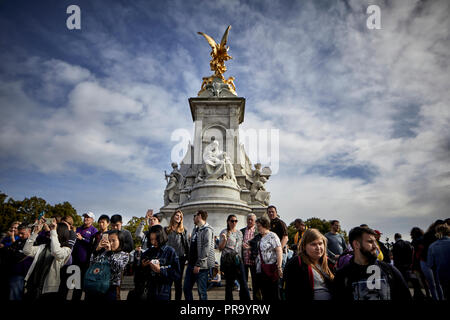 Tourists waiting on victoria memorial fountain outside  Buckingham Palace  City of Westminster in London the capital city of England Stock Photo