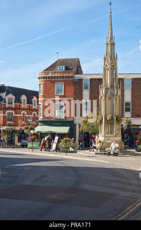 Street scene at the Market Cross and High Street in Glastonbury, Somerset, UK Stock Photo