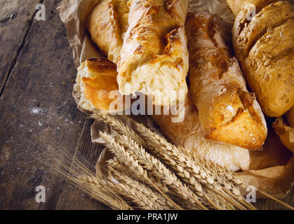 Fresh baked bread on wooden background Stock Photo