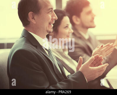 Close-up of business people clapping hands. Business seminar concept in office Stock Photo