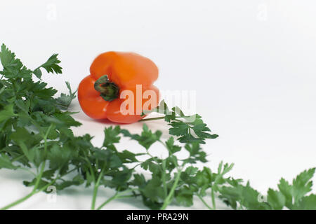 sweet pepper and sprigs of parsley isolated on white background Stock Photo