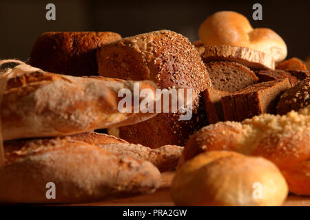 Different types of bread and buns on a wooden background Stock Photo