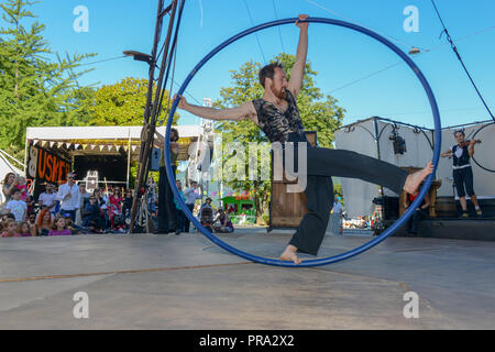 Lugano, Switzerland - 15 July 2016 - Acrobat on a hula hoop does tricks at Buskers Festival in Lugano, Switzerland Stock Photo