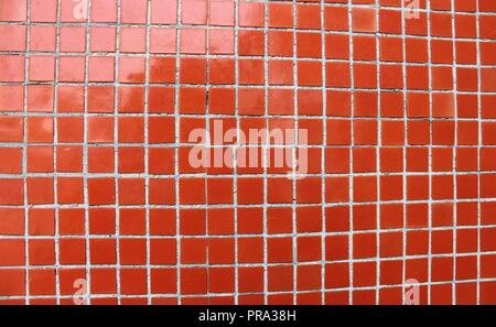 Red mosaic tiles on a wall Stock Photo