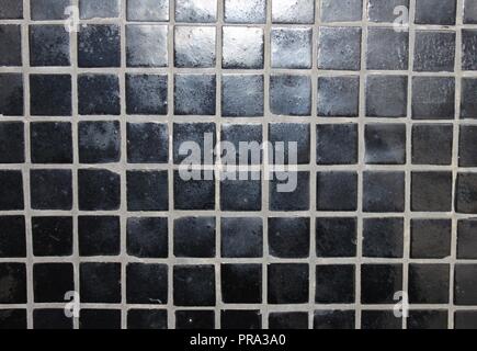 Black mosaic tiles on a wall Stock Photo