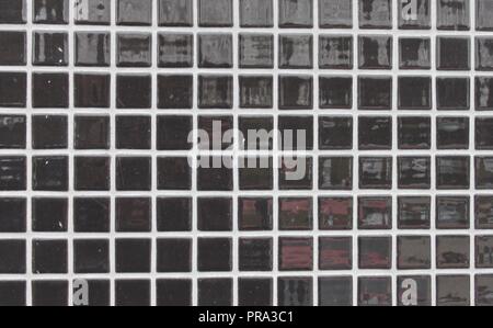 Black mosaic tiles on a wall Stock Photo
