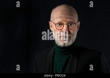 portrait of serious senior man on black background Stock Photo