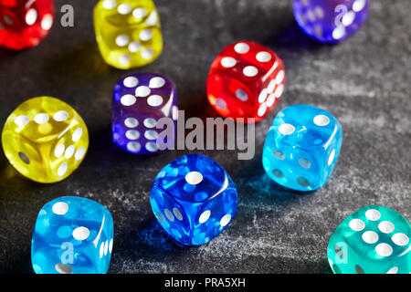 Colorful dice on a dark background, selective focus. Stock Photo