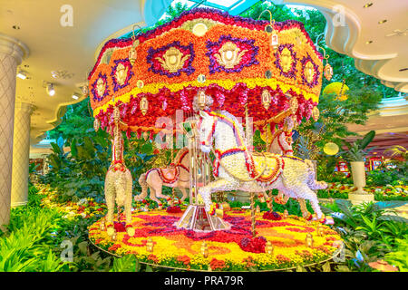 Las Vegas, Nevada, USA - August 18, 2018: flowers French carousel with horses at Wynn Hotel Casino Resort lobby, Las Vegas Strip.Preston Bailey's floral installation is made up of thousands of flowers Stock Photo