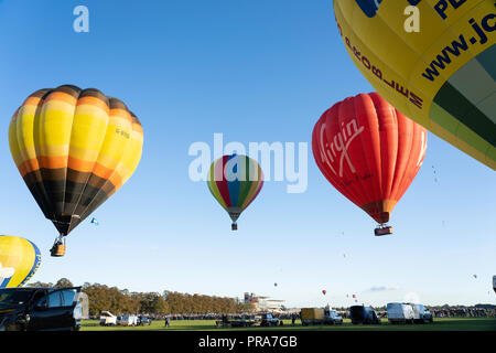 Mass multicoloured hot air balloon launch at York Balloon Fiesta, North Yorkshire, England, UK. Stock Photo