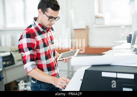Busy technician working with printer Stock Photo