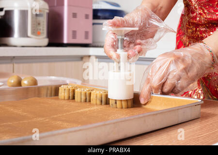 Asian chinese woman making moon cake in the kitchen at home Stock Photo