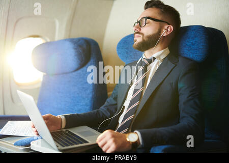 Businessman Napping in Plane Stock Photo