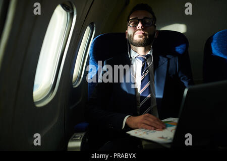 Businessman Sleeping in Flight Stock Photo