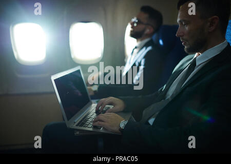 Business People in Plane Stock Photo