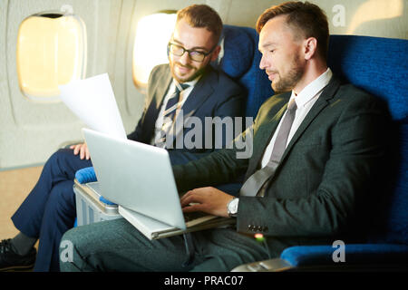Unrecognizable Businessman in Plane Stock Photo