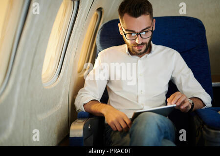 Man in Window Seat Stock Photo
