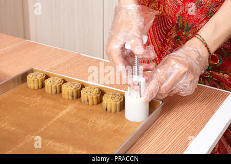 Asian chinese woman making moon cake in the kitchen at home Stock Photo