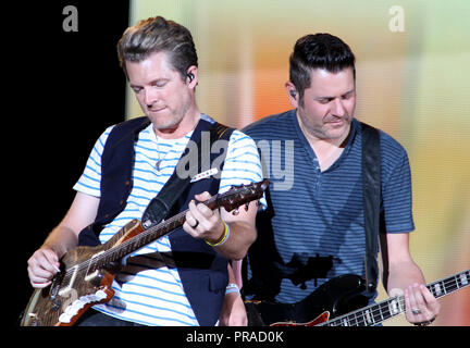 Joe Don Rooney (L) and Jay DeMarcus with Rascal Flatts perform in concert at the Cruzan Amphitheatre in West Palm Beach, Florida on September 13, 2014. Stock Photo